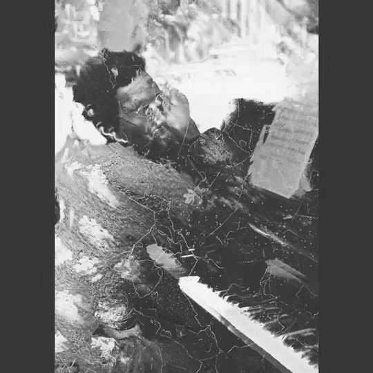 A distorted photograph of a man playing the piano.