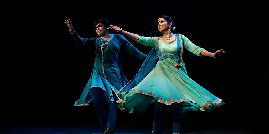 The photo shows a man and a woman dancing. They are both wearing dance attire and appear to be engaged in a choreographed performance. The image captures a moment of movement and expression in the art of dance.